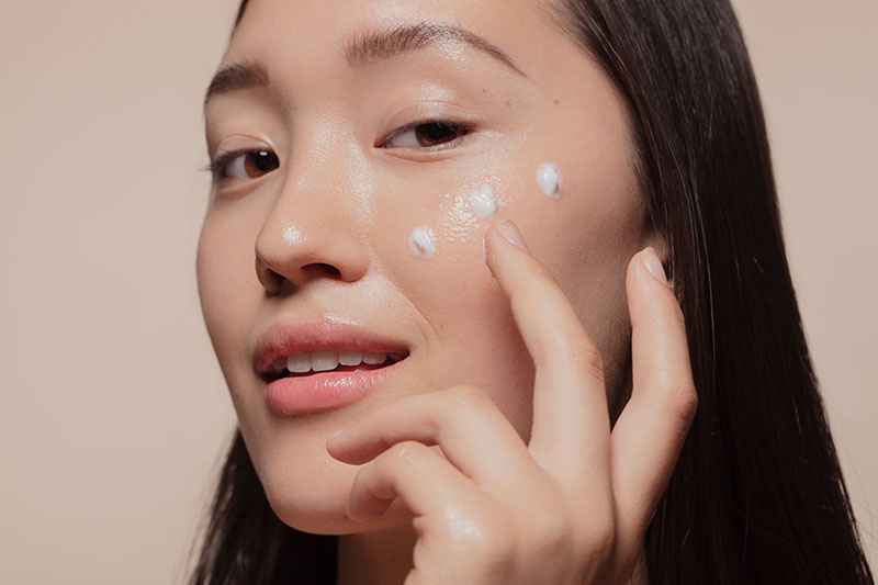 Online Retailer Customer Type Image features a model with skin care dots on her face