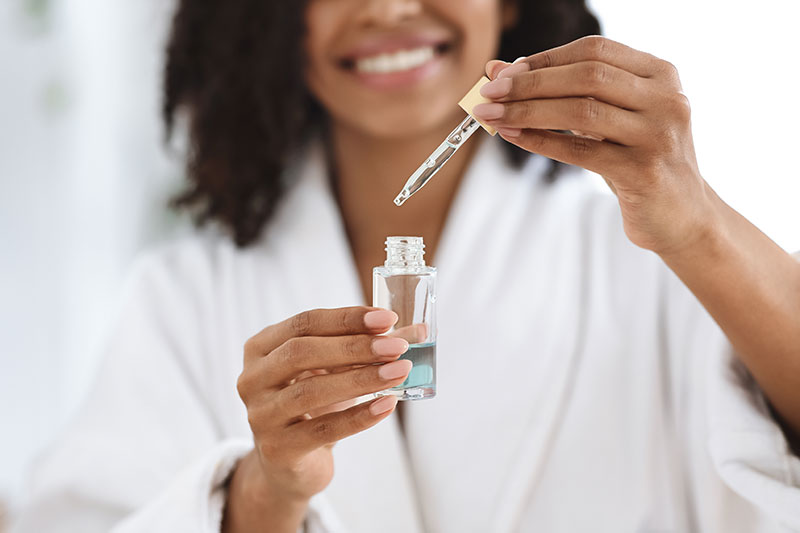 Other Customer Type Image for Skin Care Customer type featuring a model holding a dropper formula